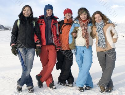 Group of sports teenagers in winter mountains