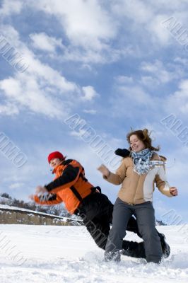 Couple jump over blue sky in winter Couple jump over blue sky in winter