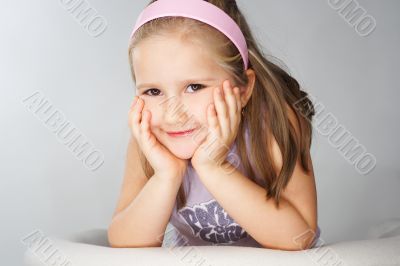 Nice young girl in pink on light background