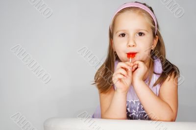 Nice young girl in pink on light background