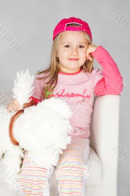 Nice young girl in pink on light background