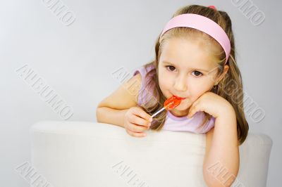 Nice young girl in pink on light background