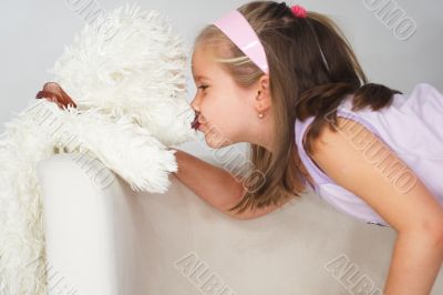 Nice young girl in pink on light background
