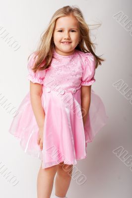 Nice young girl in pink on light background