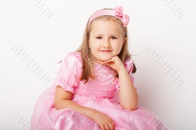 Nice young girl in pink on light background
