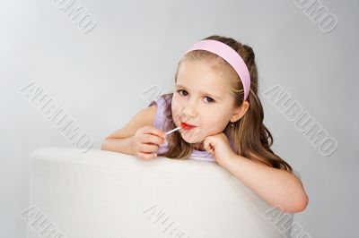 Nice young girl in pink on light background