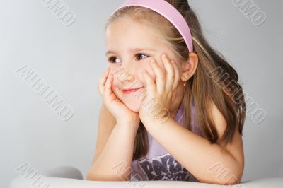 Nice young girl in pink on light background