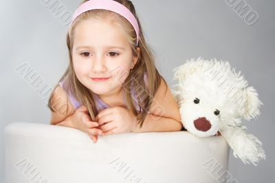 Nice young girl in pink on light background