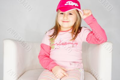 Nice young girl in pink on light background