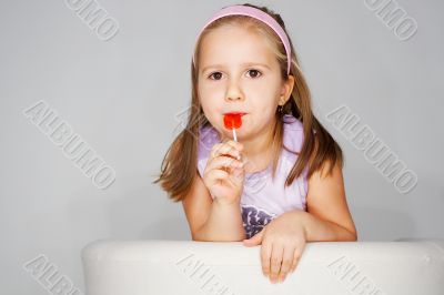 Nice young girl in pink on light background