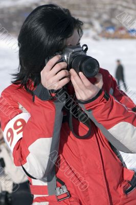 Attractive woman in sport wear holding a camera