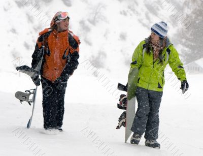 A lifestyle image of two young snowboarders