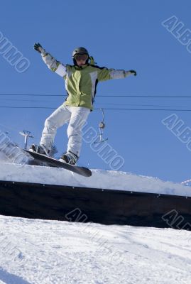 Snowboarder pull-up a sweet grab off a jump