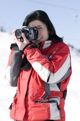 Attractive woman in sport wear holding a camera