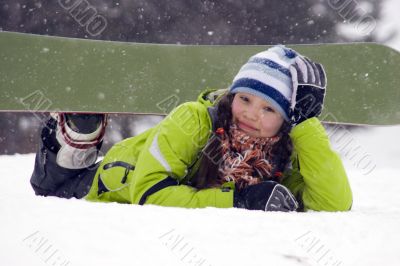 Laughing beautiful girl snowborder, snowfall