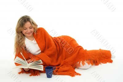 Cozy girl reading a book, smiling
