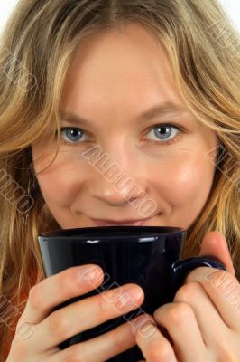Charming young woman drinking tea