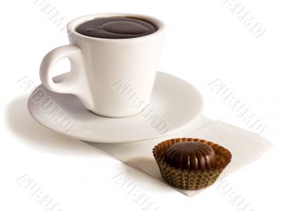 A cup of hot chocolate and a bonbon