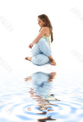 half lord of the fishes pose on white sand