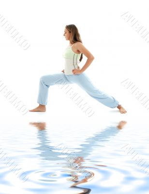 virabhadrasana warrior pose on white sand