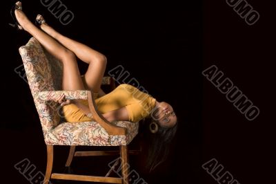 Glamorous black girl with legs high in chair (eyes open)