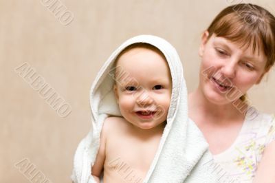 Happy mother with baby after bath