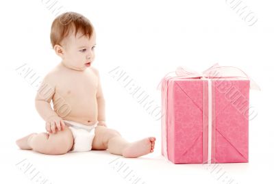 baby boy in diaper with big gift box