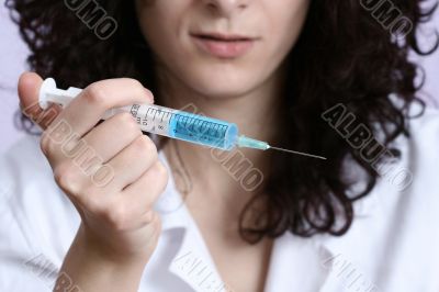 Portrait of a young doctor with syringa.