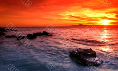 Amazing sunset over rocky seascape