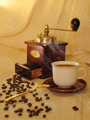 Cup of coffee with coffee mill and beans
