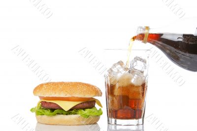 Cheeseburger and pouring soda