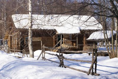 Old wooden house in snow