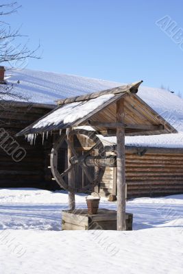 Old wooden house and draw-well