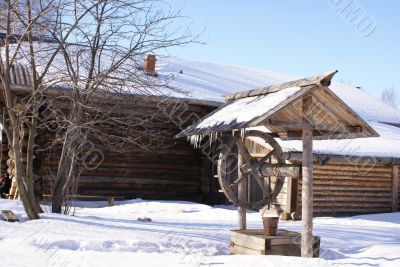 Old wooden house and draw-well