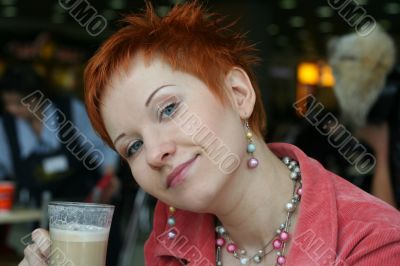 woman dreanking coffe in cafe and thoughtfully looks afar