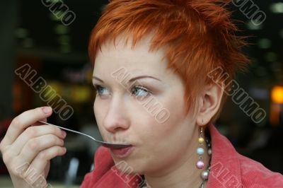 woman dreanking coffe in cafe and thoughtfully looks afar