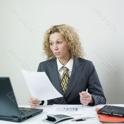 Businesswoman comparing notes