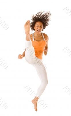 Sporty woman jumping and kicking