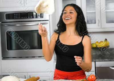 woman tossing pizza dough