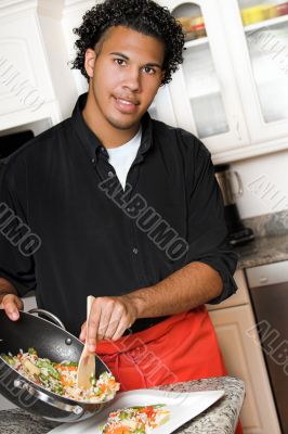 young chef plating food young chef plating food