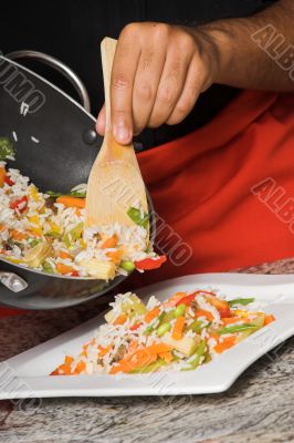 young chef plating food young chef plating food