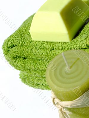 Green towels, soap and candle