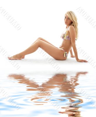 sporty girl in bikini on white sand
