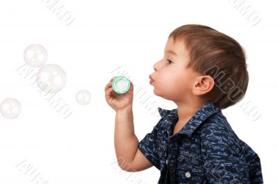 little boy blow bubbles