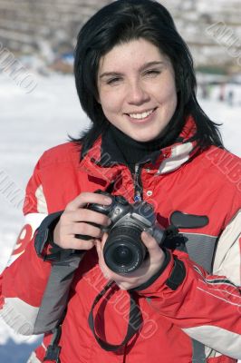 Attractive woman in sport wear holding a camera