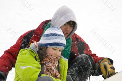 A lifestyle image of two young snowboarders
