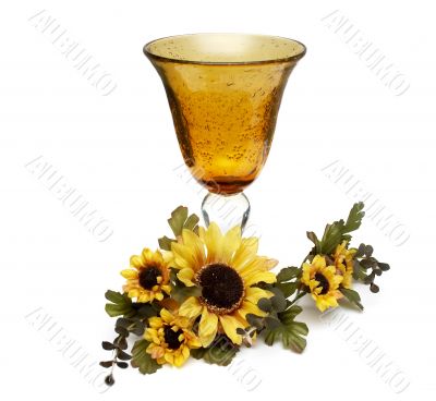 Big yellow wineglass with bouquet of sunflowers