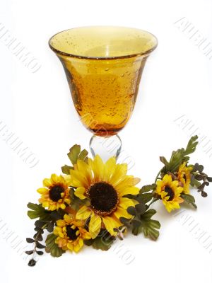 Big yellow wineglass with bouquet of sunflowers