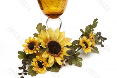 Big yellow wineglass with bouquet of sunflowers