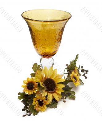 Big yellow wineglass with bouquet of sunflowers